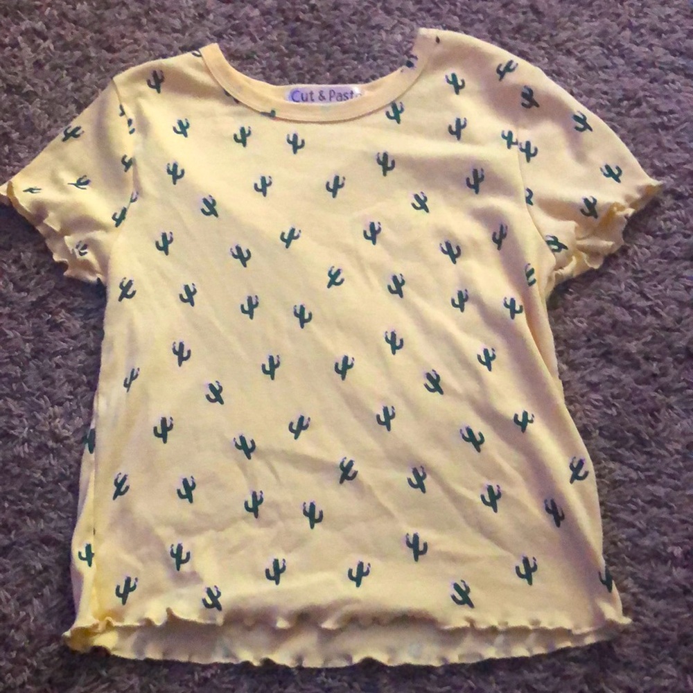 This is a medium sized top from Cut & Paste. It is yellow with green cactuses..